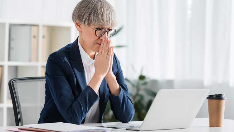 Worried fundraiser gazing into her laptop